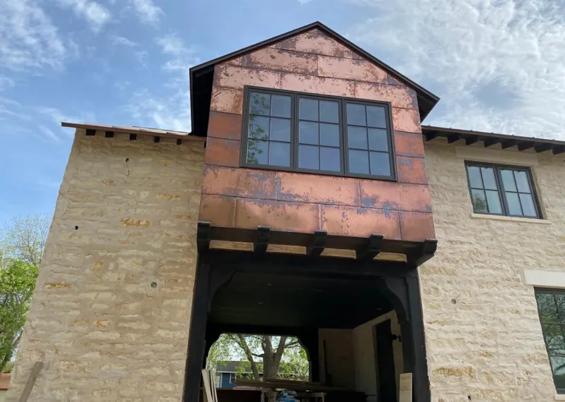 Copper metal panel facade on a stone building for Roof Repair in Chowchilla